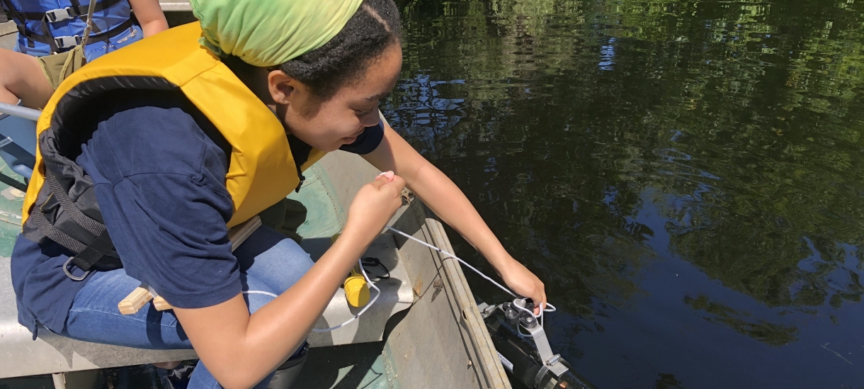 A student sampling water in Paramecium Pond