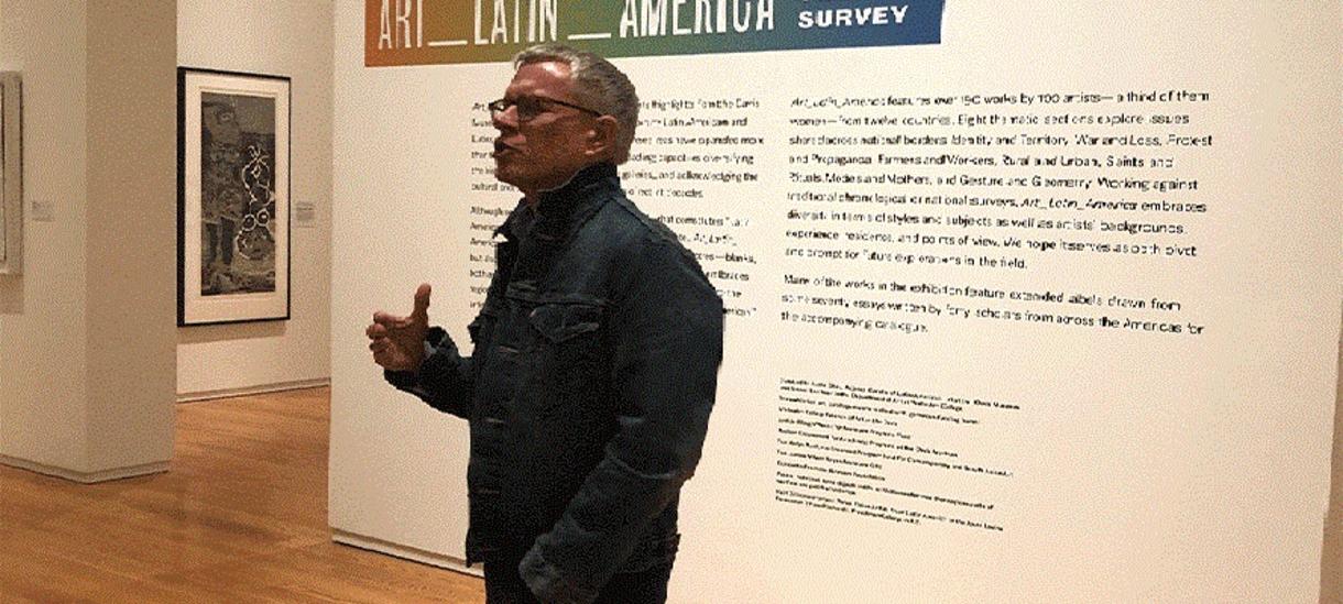 Person speaking in a Latin American art gallery