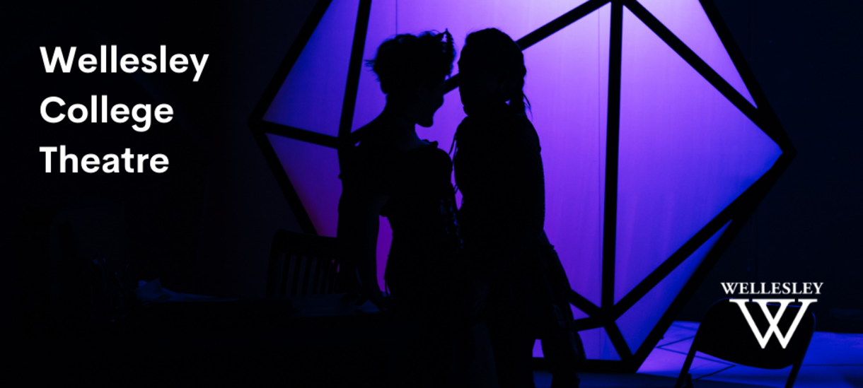 Two actors embracing in shadow