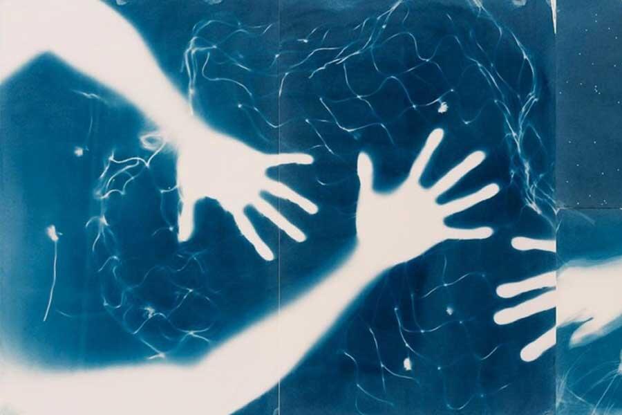 abstract photo of white hands against blue background
