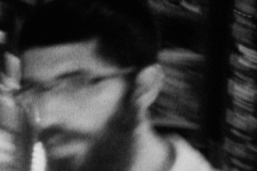 blurred black and white image of a man's face, movie still from 400 shots