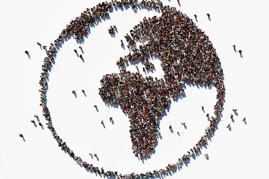 image of people standing in the shape of the world globe.