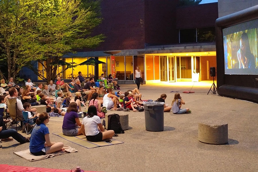 People sitting on the Davis Plaza viewing an outdoor film