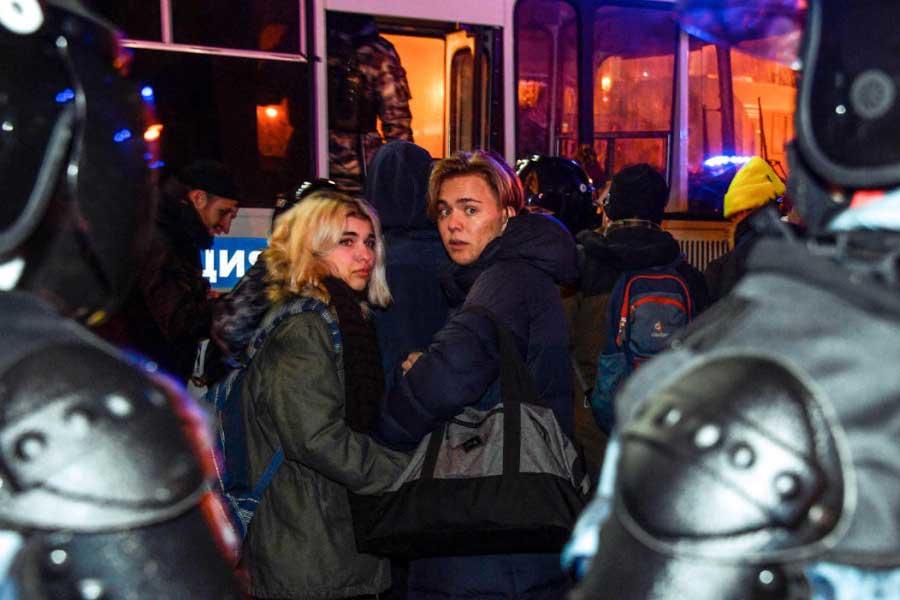 Riot police officers detain people during a protest in moscow