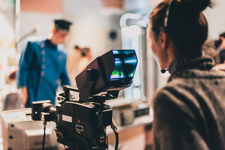 behind the scenes view of a video camera on set