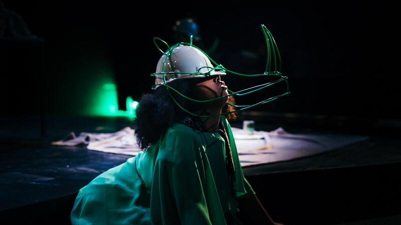 actor with green clothing and rhino head hat