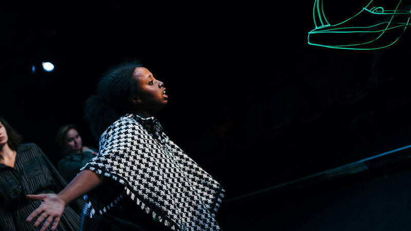 actor facing glowing rhino puppet