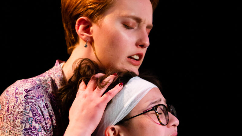 One actor caressing head of another