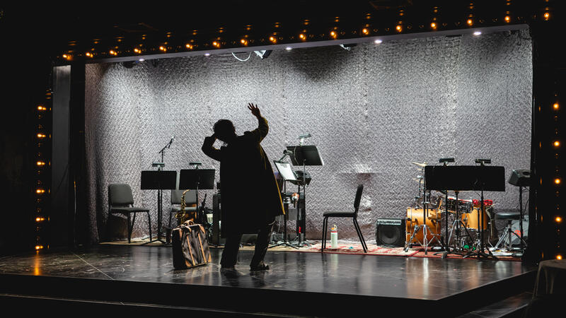 Emcee in front of empty band stage
