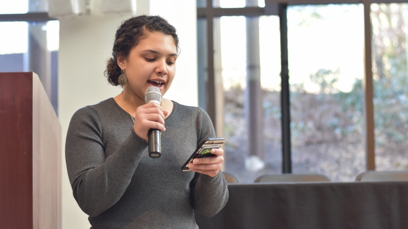 A student speaking with a microphone