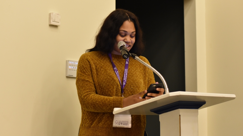 A student speaking at a podium