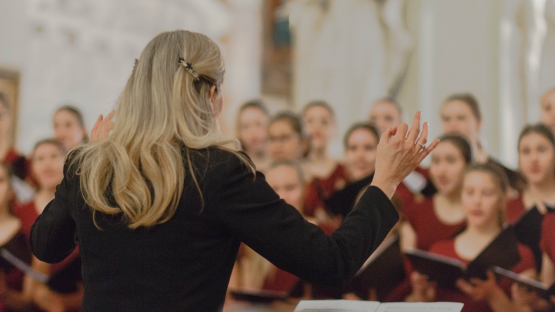director conducting in front of choir