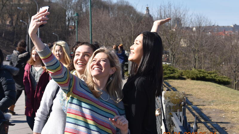 choir students and director taking a selfie on a trip