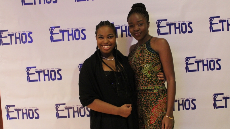 Two students standing in dresses for the Ethos gala