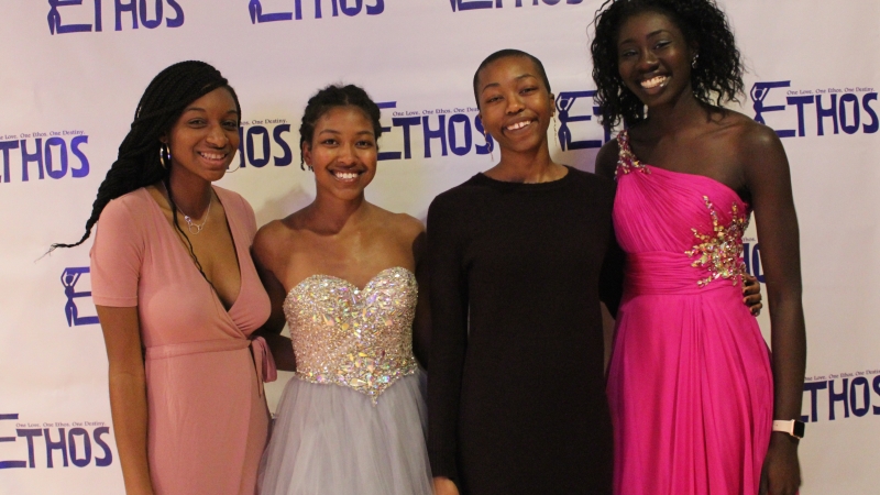 Four students standing in dresses for the Ethos gala