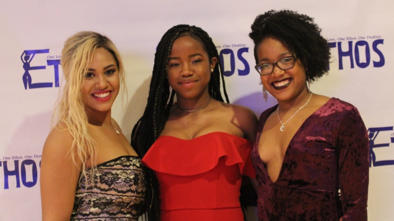 Three students standing in dresses for the Ethos gala