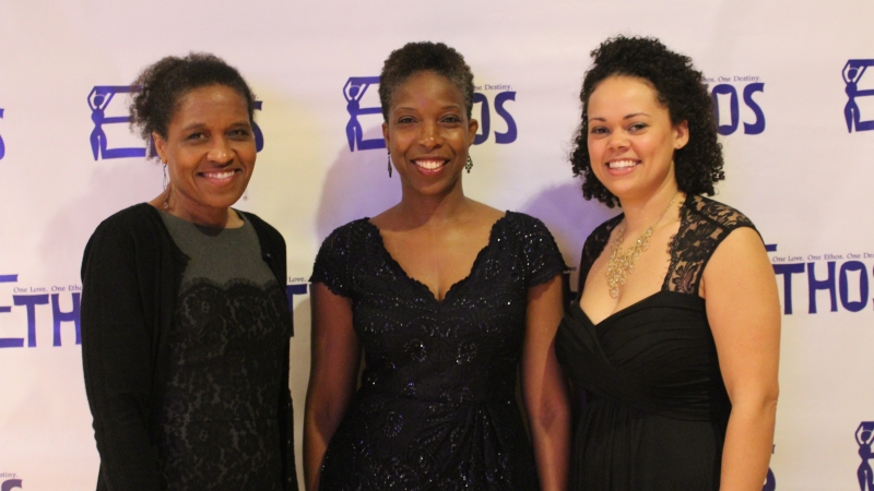 Three students standing in dresses for the Ethos gala