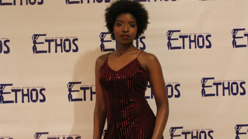 A student standing in a dress for the Ethos gala