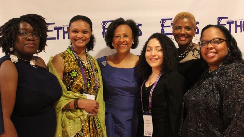 Five faculty standing in dresses for the Ethos gala