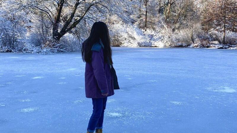 Laura Chin &lsquo;23 standing on a frozen Paramecium Pond