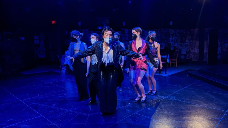 Emcee and dancers on stage