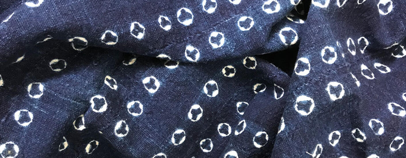 close up image of blue fabric with white dye pattern