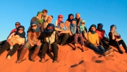students on Sahara dune