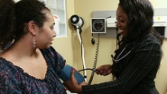 Danielle Gore '15 takes a woman's blood pressure