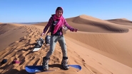 Kathy Long on sandboard in desert