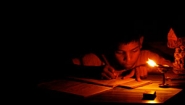 child studies by candlelight