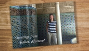 A postcard on a table shows Catherine Puga '17 in Rabat Morocco