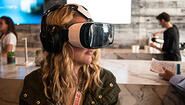 Alumna Creates Virtual Reality Museum Experiences Young woman uses virtual reality googles