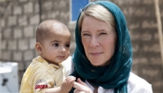 Carolyn Miles holding baby in Iraq