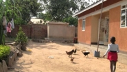 scene from Beatrice Achieng Nas video: girl with chickens