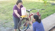 Amy Banzaert and student work on bicycle