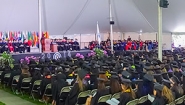 full audience under the commencement tent