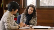 Sophie Sun '14 and director Cassandra Pattanayak work together in library office