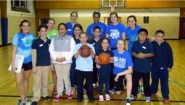 Basketball volunteers pose with students at Let's Get Movin' basketball court