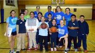 Basketball volunteers pose with students at Let's Get Movin' basketball court