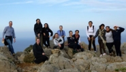 Bryan Burns and 11 students atop rocky peak in Crete