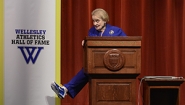 Albright shows off blue sneaker from behind podium