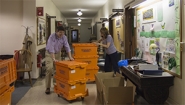 John OKeefe and Lori Tenser move orange rent-a-crates in Green Hall