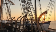 sunrise behind rigging of 1841 whaling ship