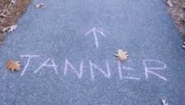 "tanner" and direction arrow chalked on sidewalk