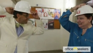 two Wellesley faculty don hard hats as they prepare to tour newly renovated Founders Hall