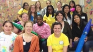 15 diverse Wellesley women pose at Cradles to Crayons