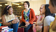 diverse group of students relaxing and laughing in library