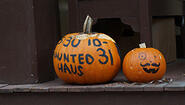 pumpkins decorated with "haunted haus" written on one