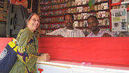 Kapteijns at counter of record stall with two Somali stall-keepers