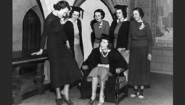 1937 photo of change of new college government pres trying on shoes of old